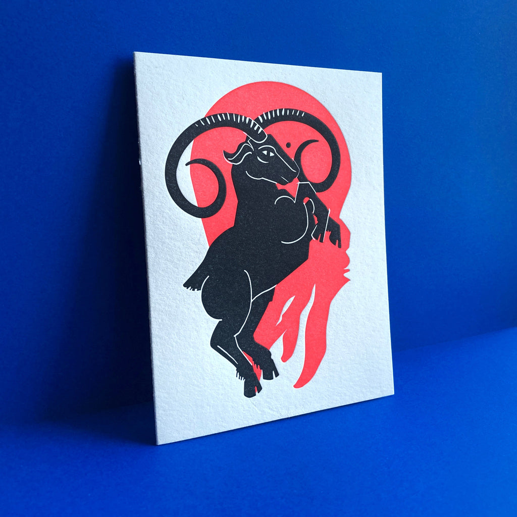 Aquarius letterpress birthday card. Black urn with all seeing eye pouring water into a esoteric waterfall. Neon red pattern in background symbolizing the fire element.