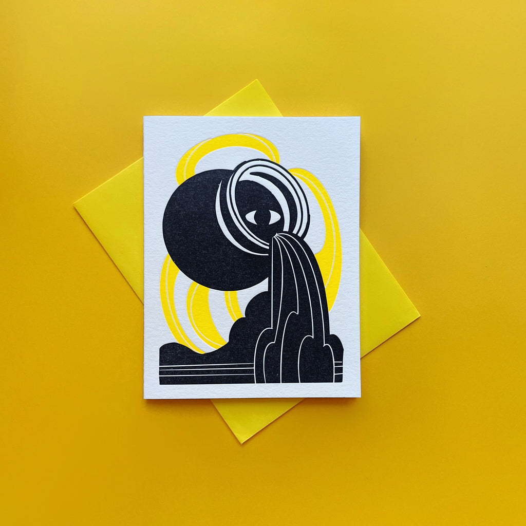 Aquarius letterpress birthday card. Black urn with all seeing eye pouring water into a esoteric waterfall. Neon yellow pattern in background symbolizing air element. Shown with bright yellow A2 envelope and yellow background.
