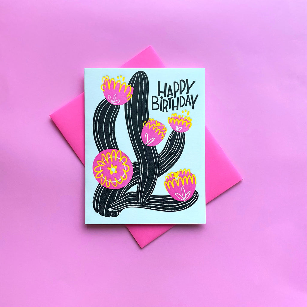 Letterpress cactus birthday card on pink background shown with neon pink envelope
