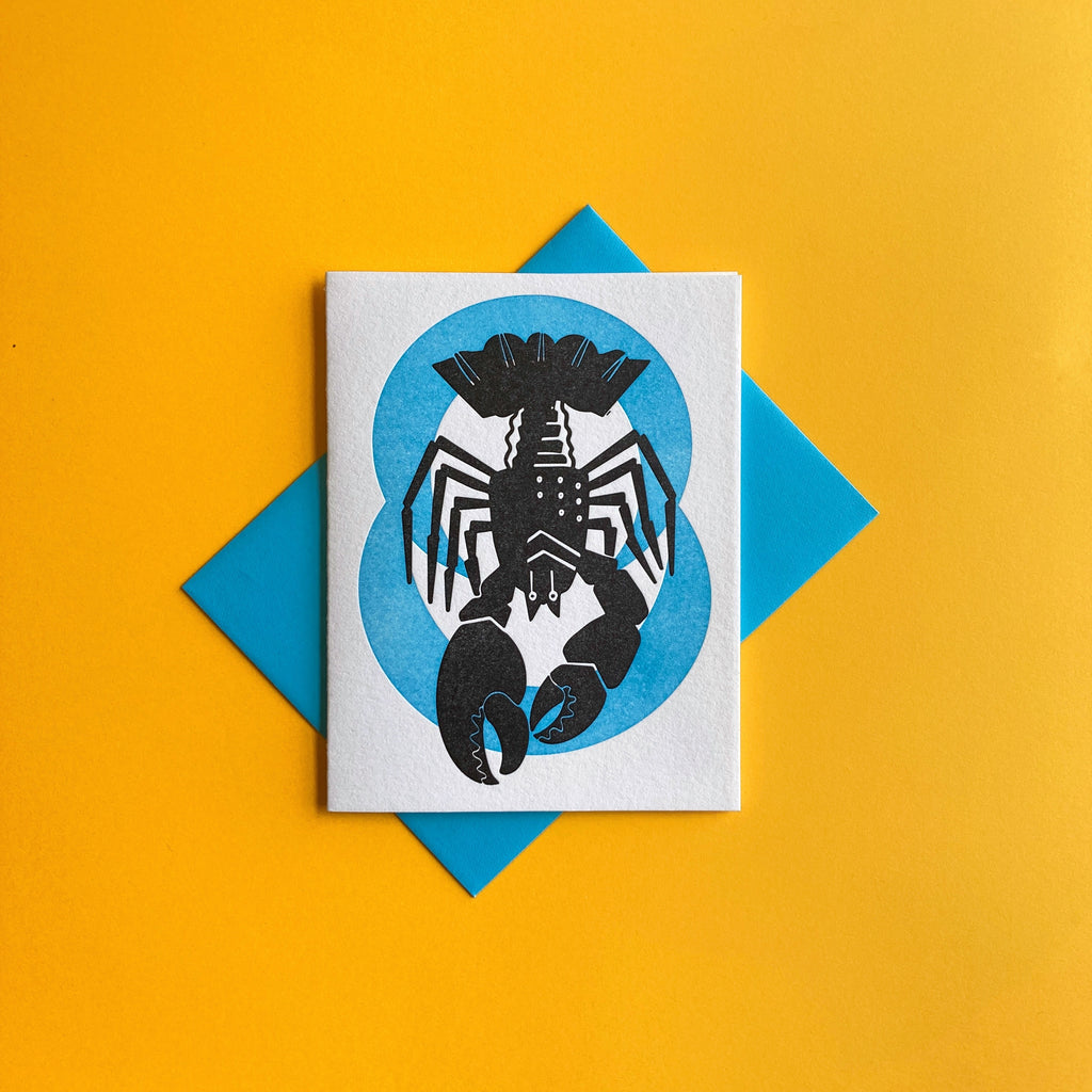  Cancer zodiac letterpress birthday card. Lobster Crawdad Crayfish black letterpress printed. Neon blue pattern in background symbolizing water element.