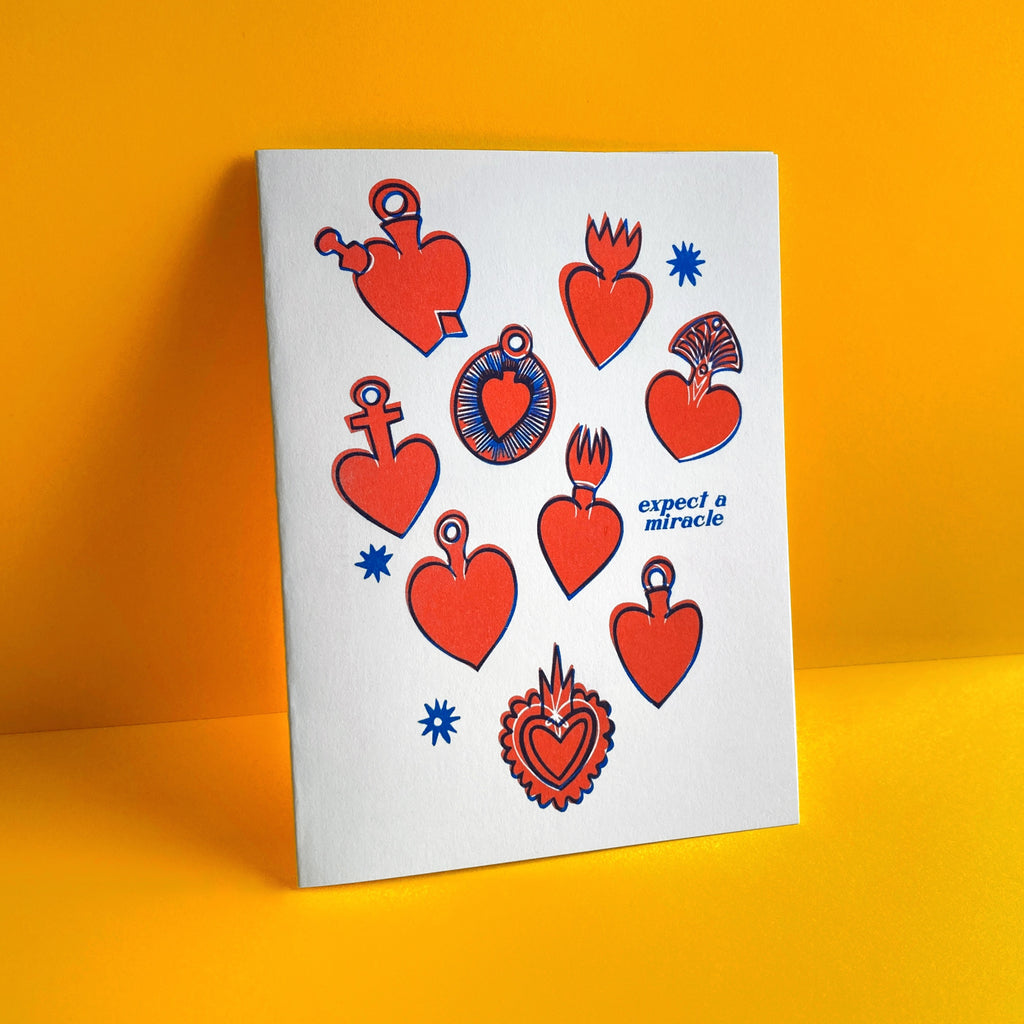 heart ex vote Milagros with text "expect a miracle" shown on a yellow background  risograph